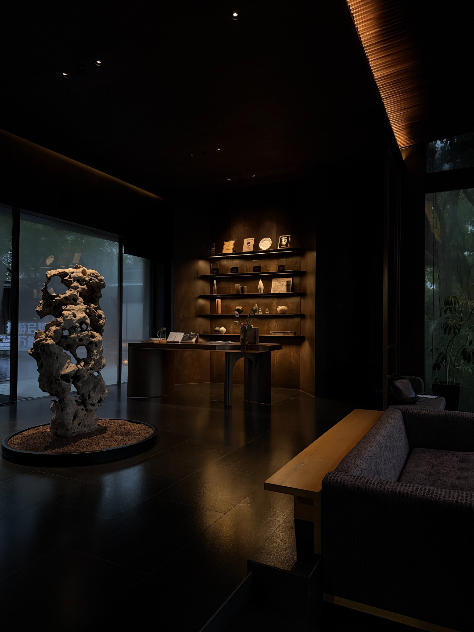 Dark modern interior with sculptural stone